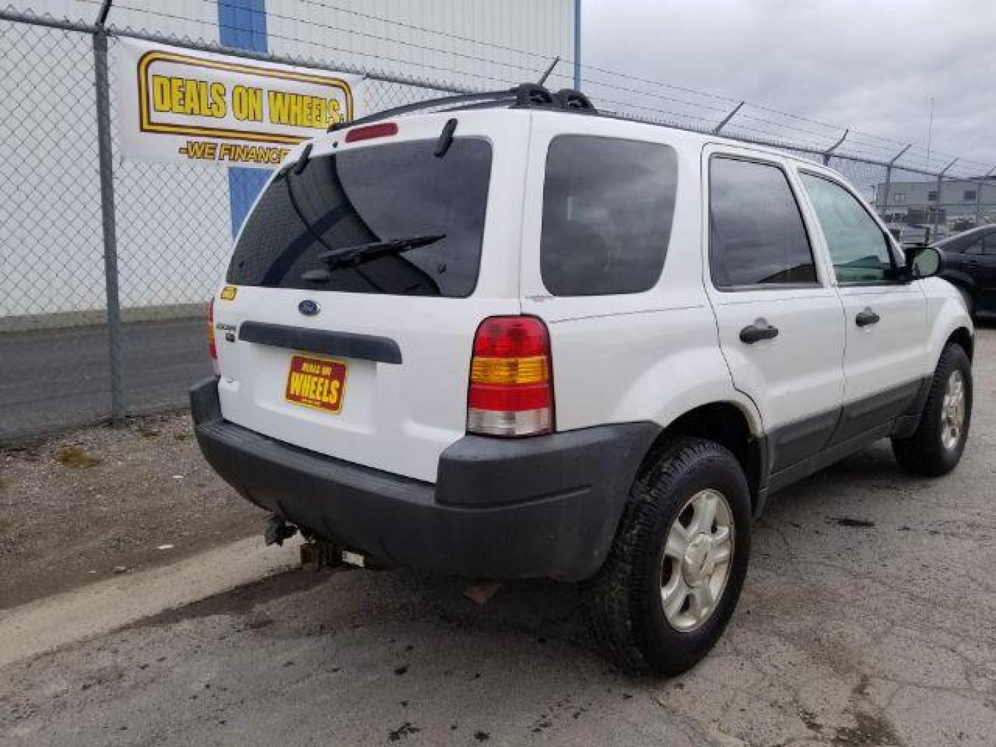 2004 Oxford White Ford Escape XLT 4WD (1FMYU93114D) with an 3.0L V6 DOHC 24V engine, 4-Speed Automatic transmission, located at 1821 N Montana Ave., Helena, MT, 59601, (406) 422-1031, 0.000000, 0.000000 - Photo#4